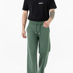 man standing straight in dark green wide leg joggers
