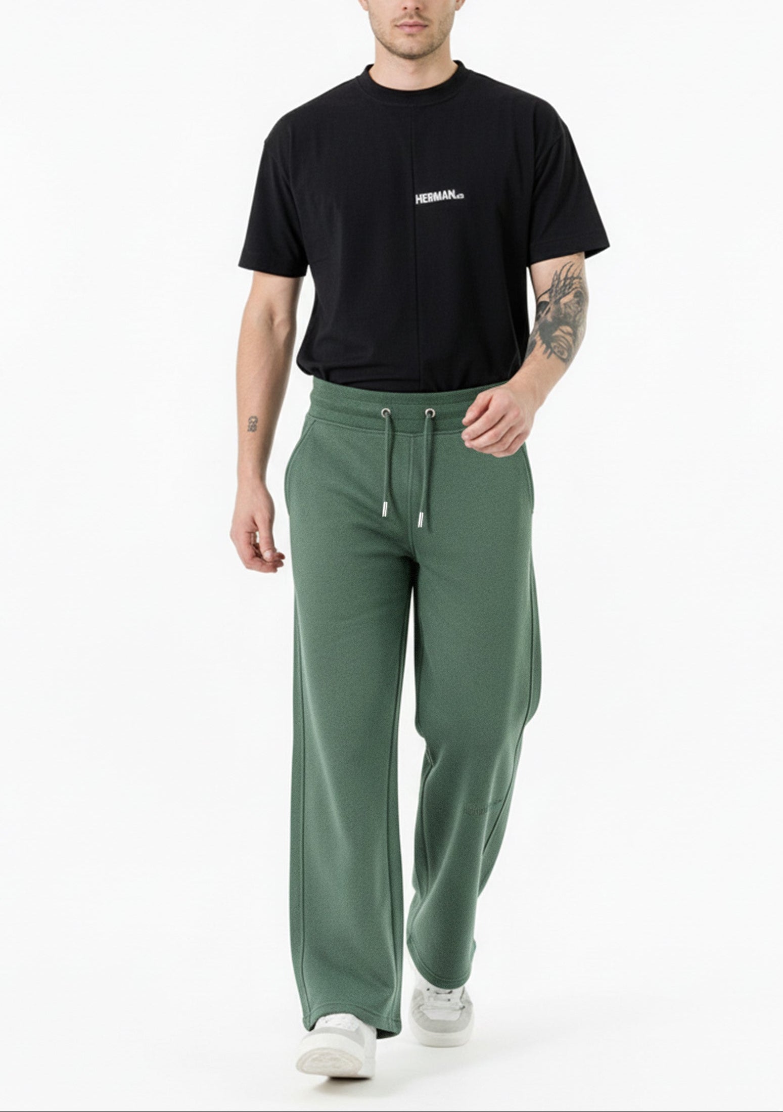 man standing straight in dark green wide leg joggers