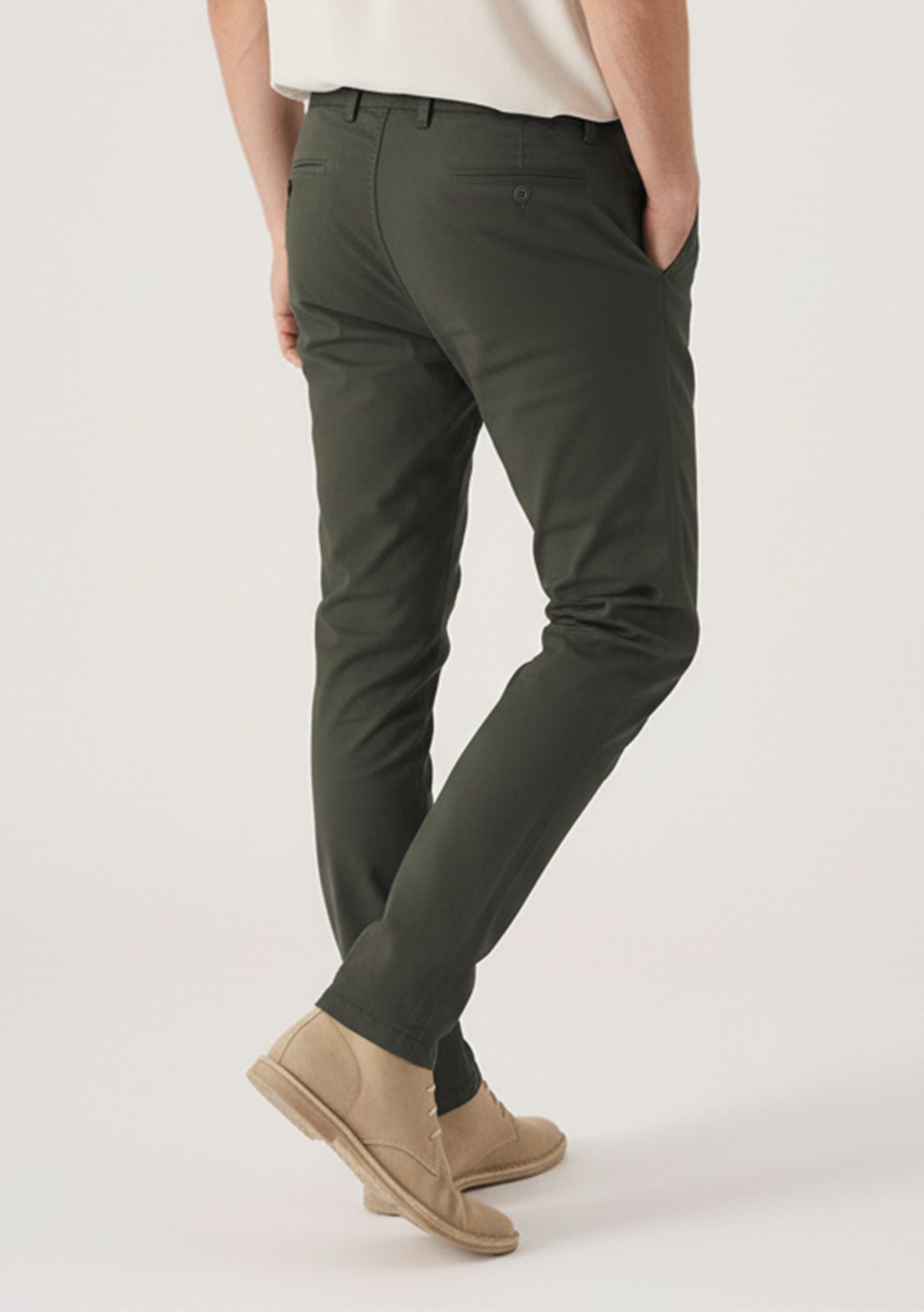 Detailed rear view highlighting the welt pockets and fit of the dark olive trousers.