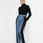 Angled side view of dual wash high-rise denim pants showing the transition from light blue to black.