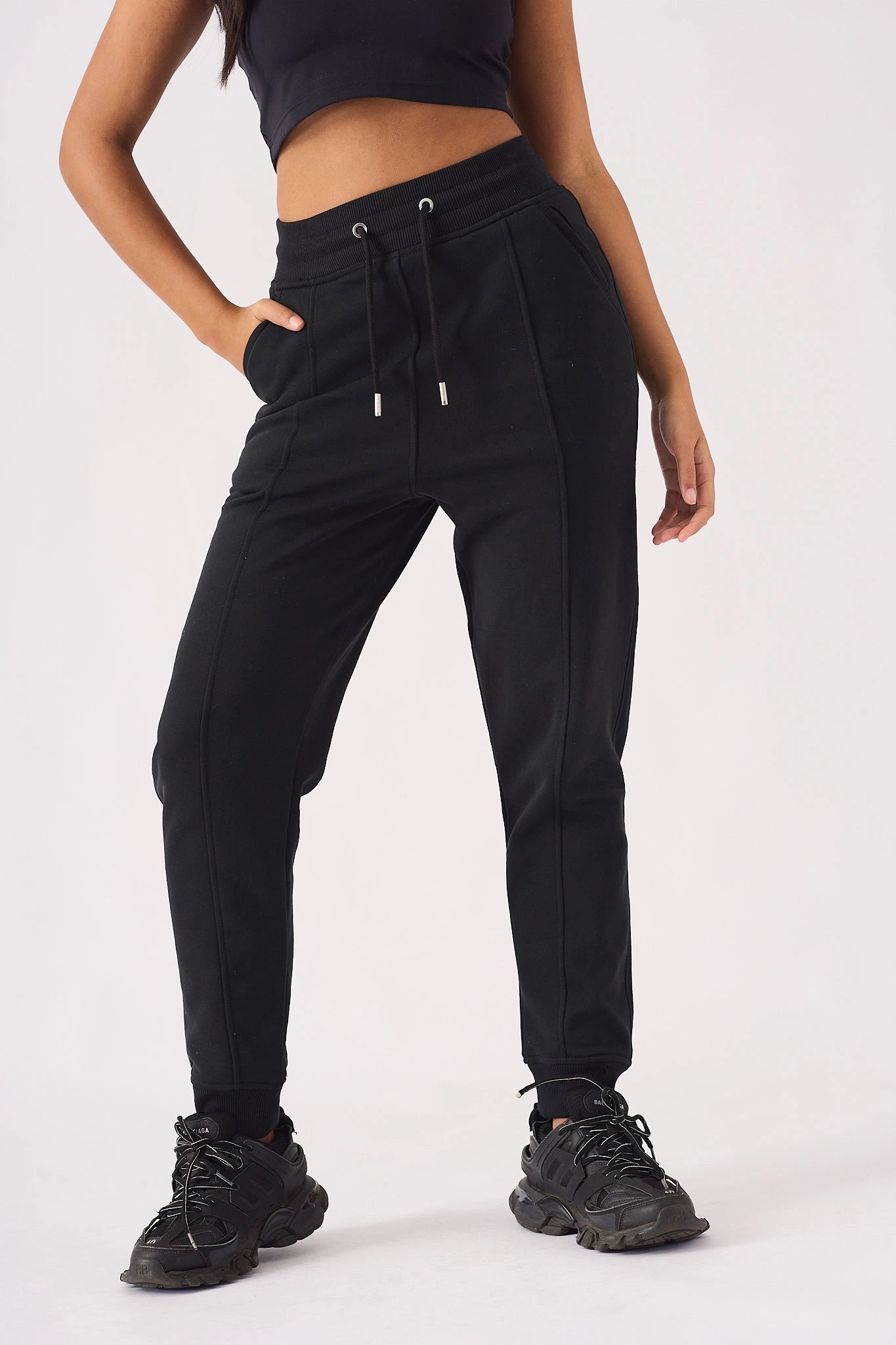 Close up detail of drawstring waist and pockets on black jogger