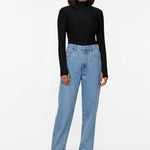 Model standing in a relaxed pose wearing female straight jeans with embellished front pockets.