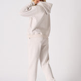 Rear view of a comfortable stone hoodie for women with a relaxed fit