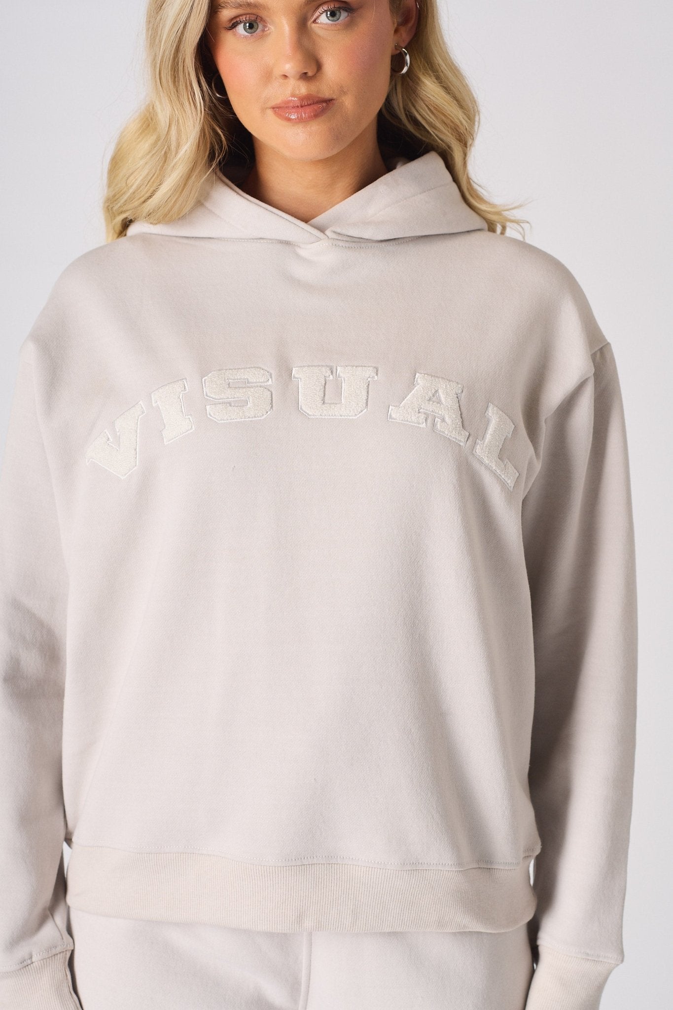 Close up detail of the textured towelling graphic on a stone hoodie