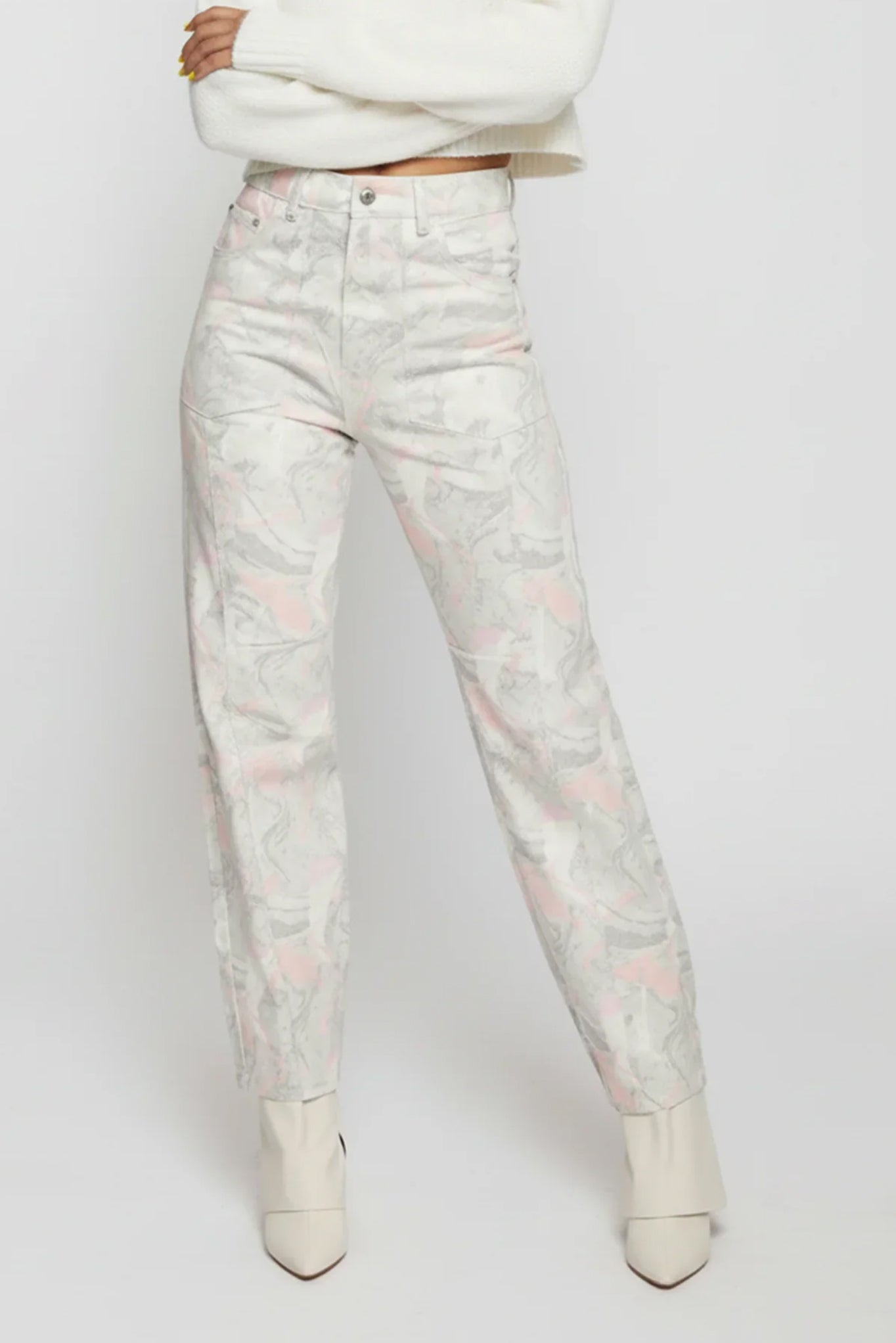 Floral-patterned jeans worn by a person on a white background