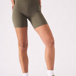 Detail shot of the wide elasticated waistband on the green cycling shorts