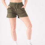 Detailed side view of the soft cotton blend fabric on these green jogger shorts