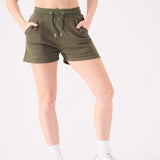 Detailed side view of the soft cotton blend fabric on these green jogger shorts