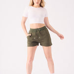 Close up front view of the adjustable drawstring waist on the green jogger shorts