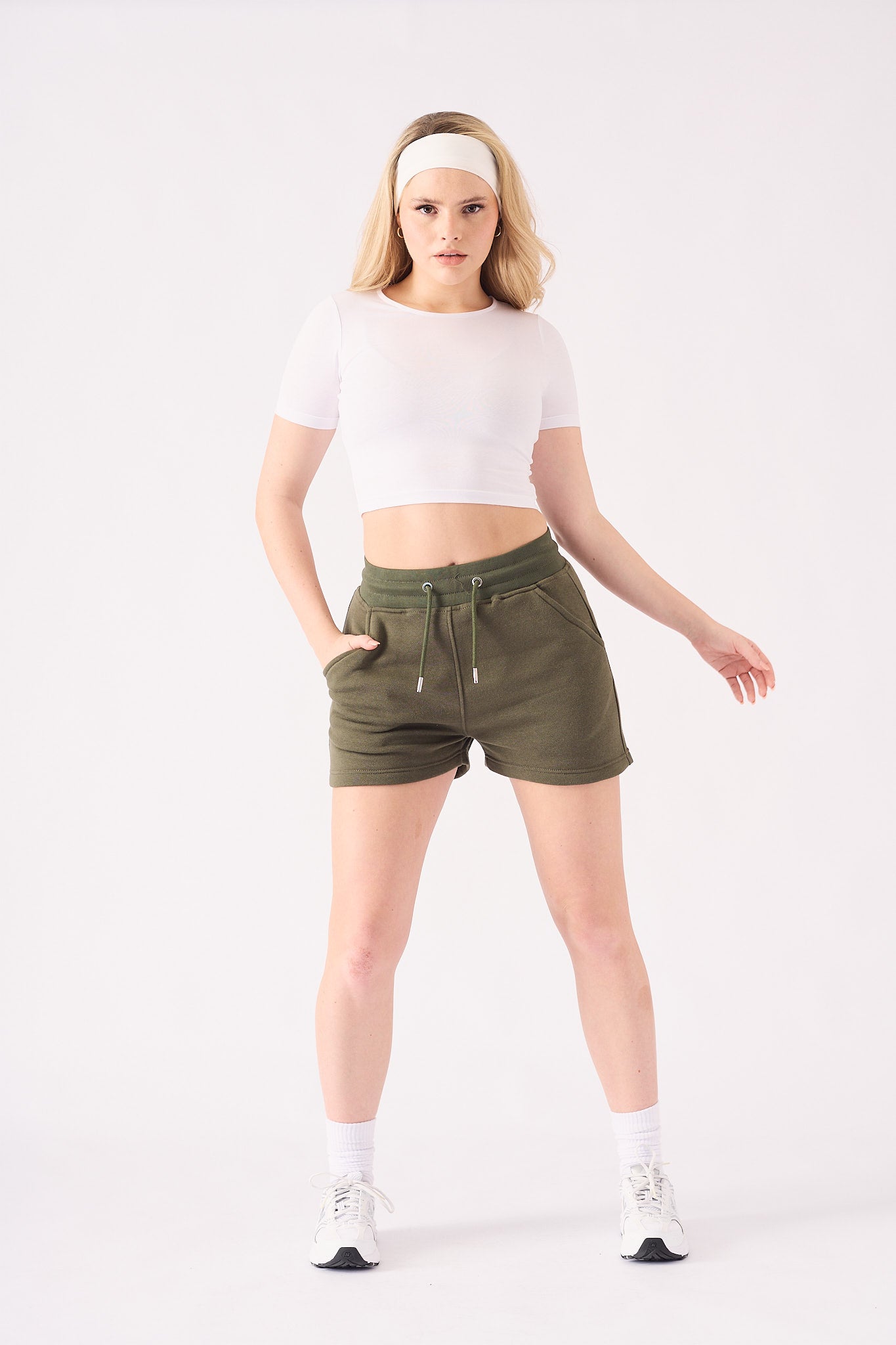 Close up front view of the adjustable drawstring waist on the green jogger shorts