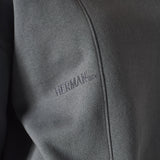 close up of embroidered logo on grey crew neck jumper