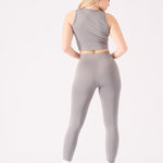 Rear view of a model in a grey racer neck crop top and matching se