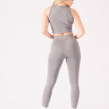 Rear view of a model in a grey racer neck crop top and matching se