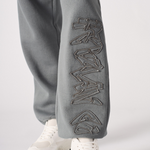 Close up of the architectural tonal embroidery on the grey cuffed joggers womens.