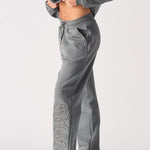 Side profile showing the relaxed silhouette of the grey cuffed joggers womens.