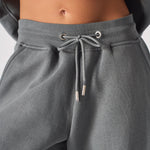 Detailed shot of the adjustable drawstring waist on grey cuffed joggers womens.