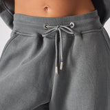 Detailed shot of the adjustable drawstring waist on grey cuffed joggers womens.