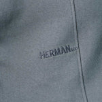 close up of tonal chest embroidery on grey oversized jumper