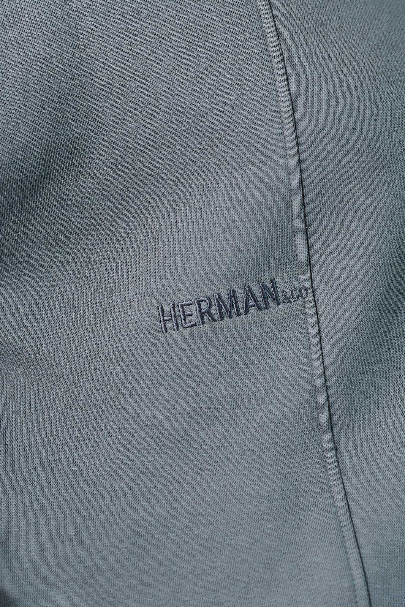 close up of tonal chest embroidery on grey oversized jumper