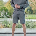 full length view in grey oversized crew neck jumper with matching shorts