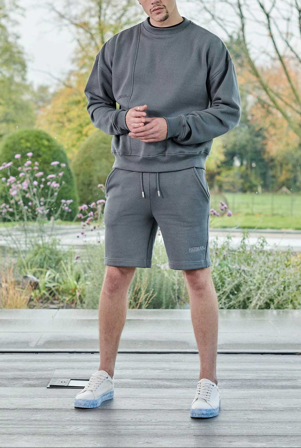 full length view in grey oversized crew neck jumper with matching shorts