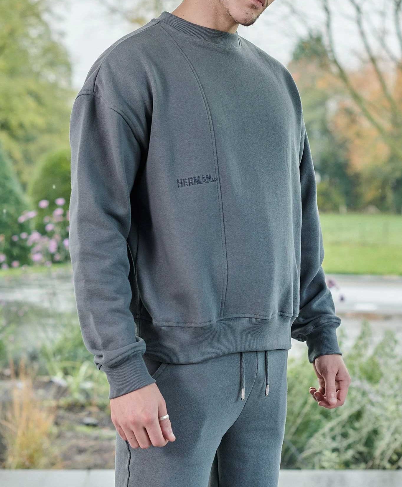 side profile showing relaxed fit in grey oversized crew neck jumper