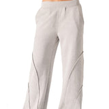 A woman wearing stylish grey seam detail wide leg joggers women in a front view.