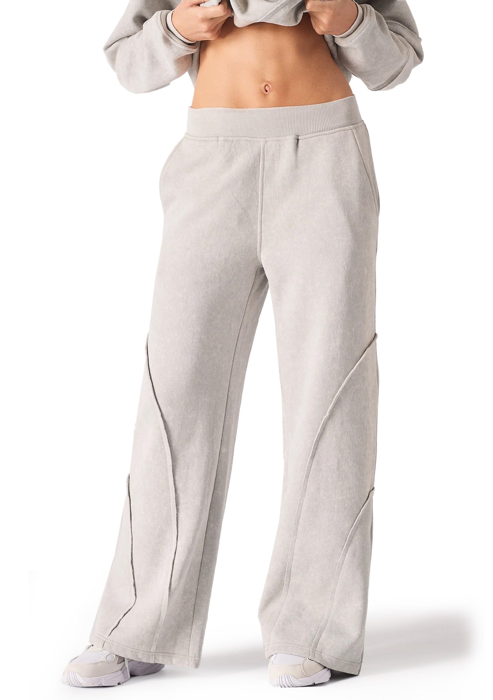 A woman wearing stylish grey seam detail wide leg joggers women in a front view.
