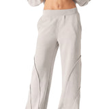 Full length front shot of a model wearing high quality grey seam detail wide leg joggers women.