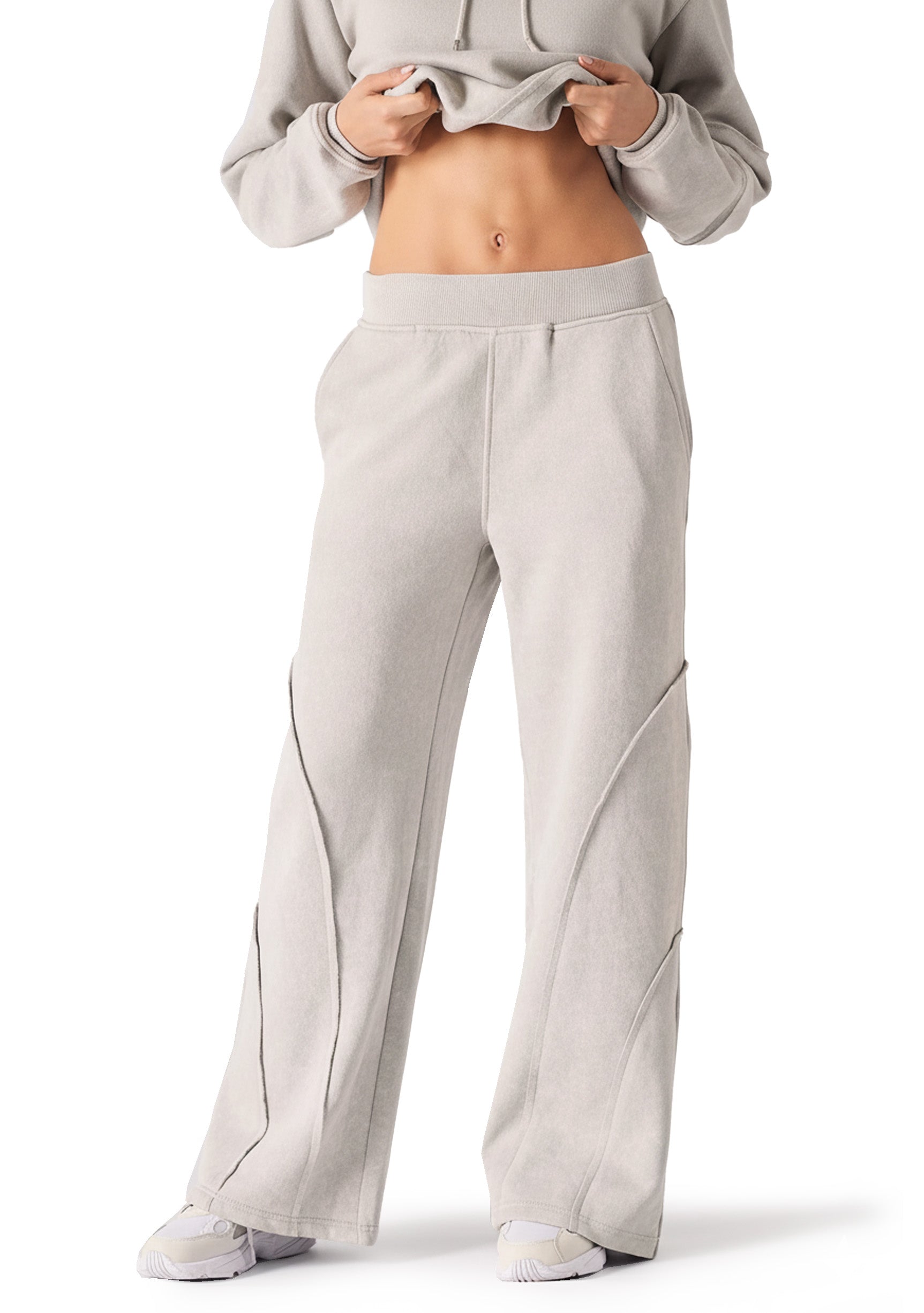 Full length front shot of a model wearing high quality grey seam detail wide leg joggers women.