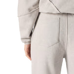 Close up shot of the unique architectural seam detailing on the grey wide leg joggers.