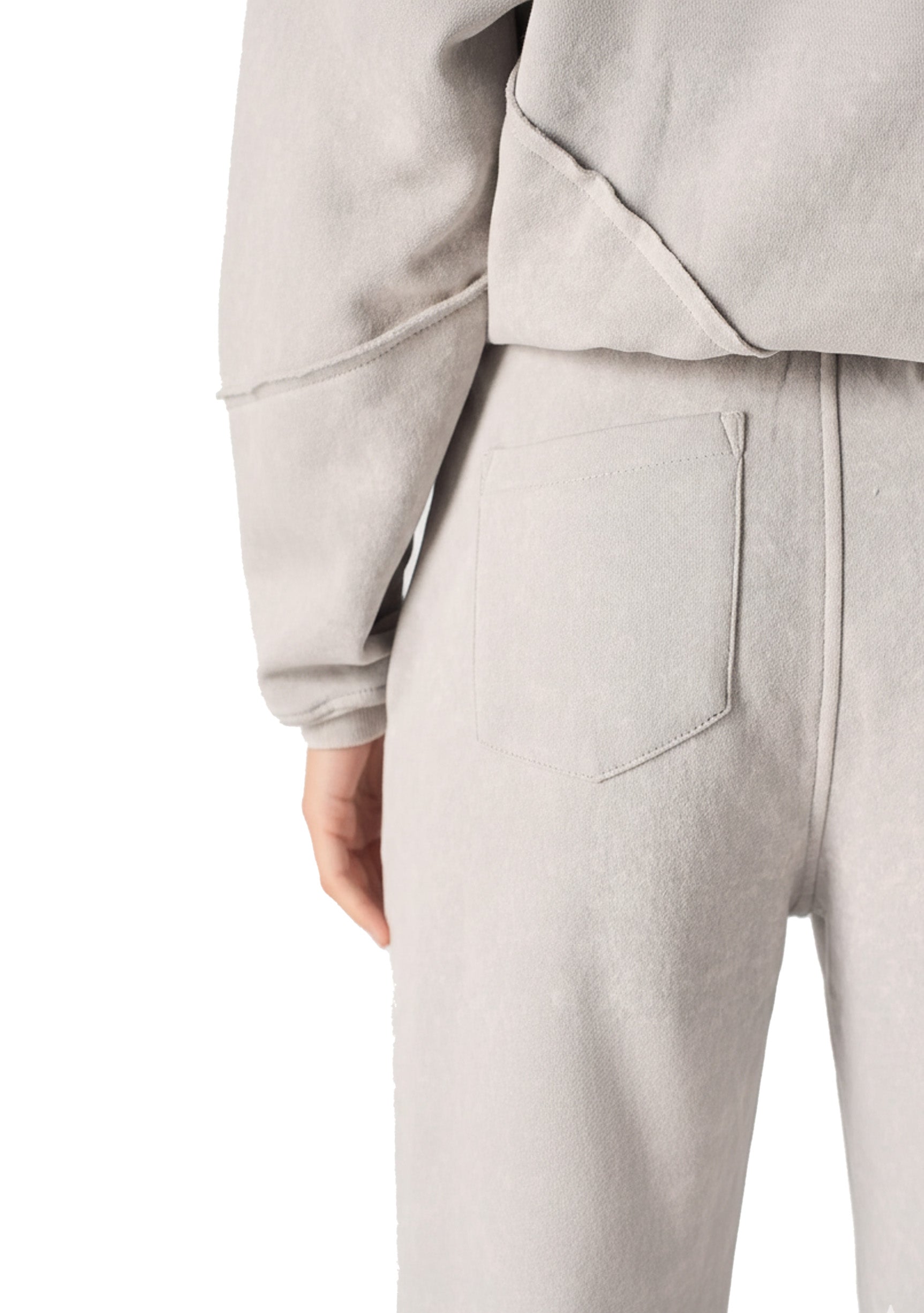 Close up shot of the unique architectural seam detailing on the grey wide leg joggers.