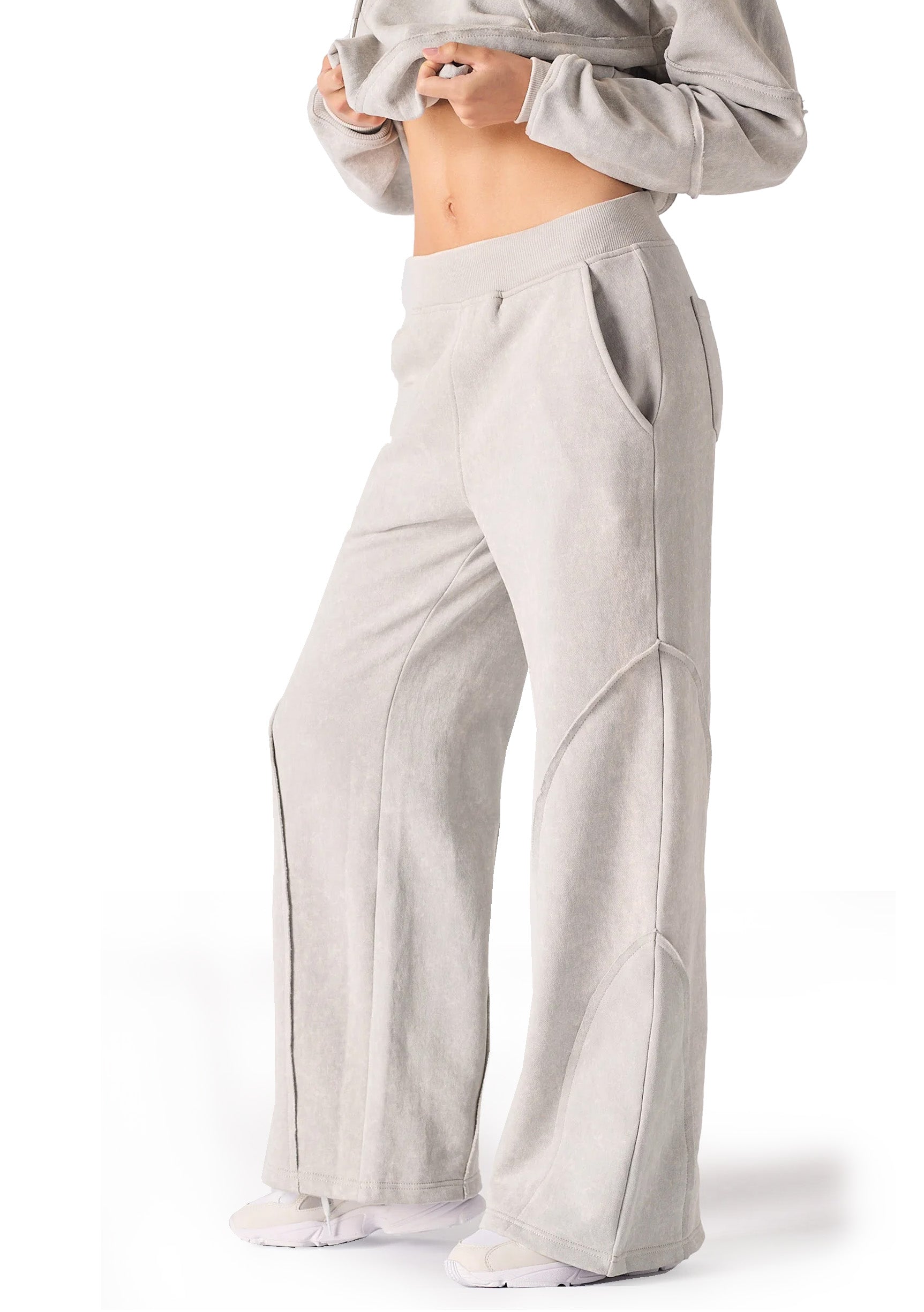 Side profile of a model posing in comfortable grey seam detail wide leg joggers women.