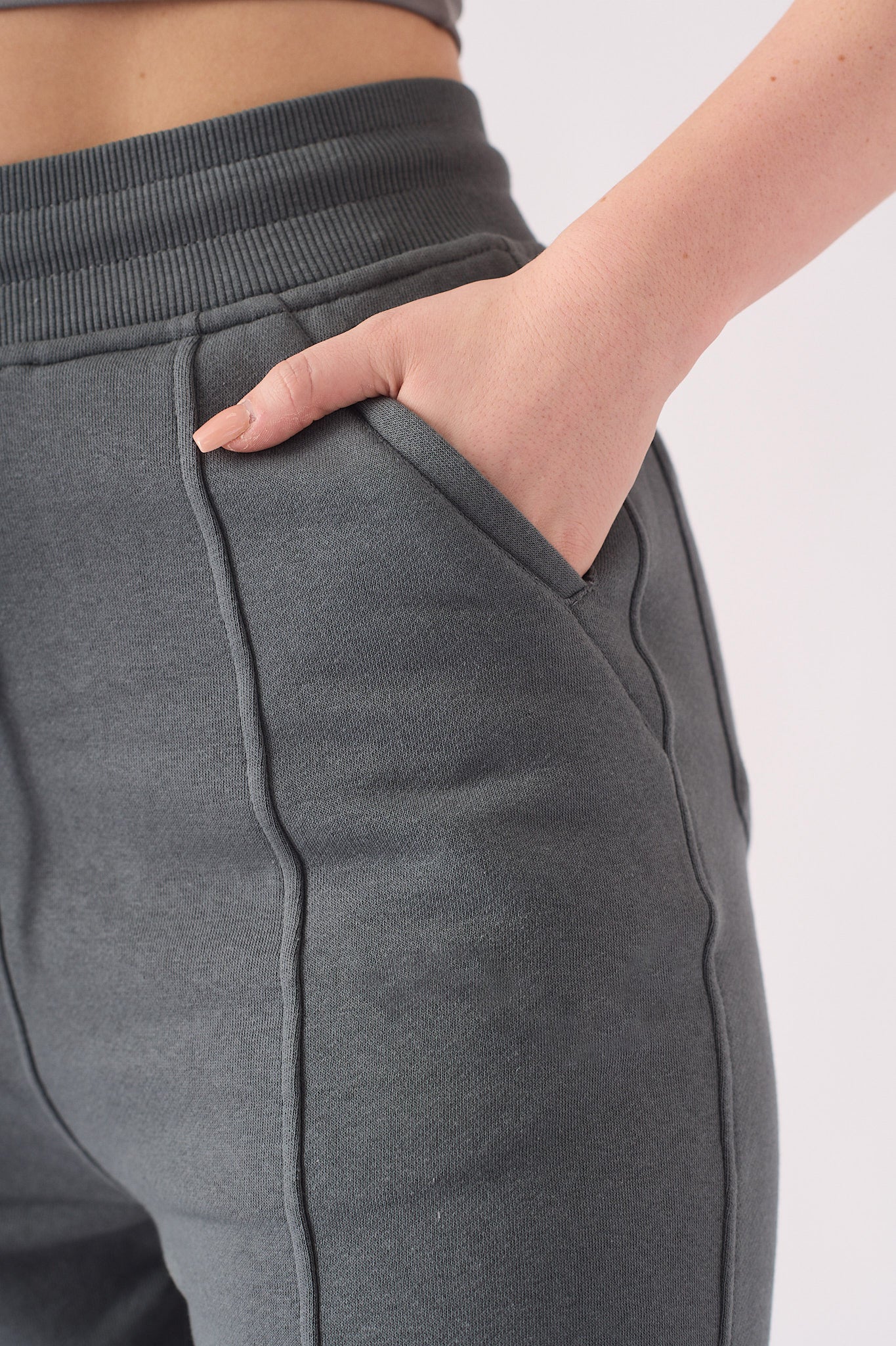 Close up shot of the hand pocket on the grey tapered joggers womens.