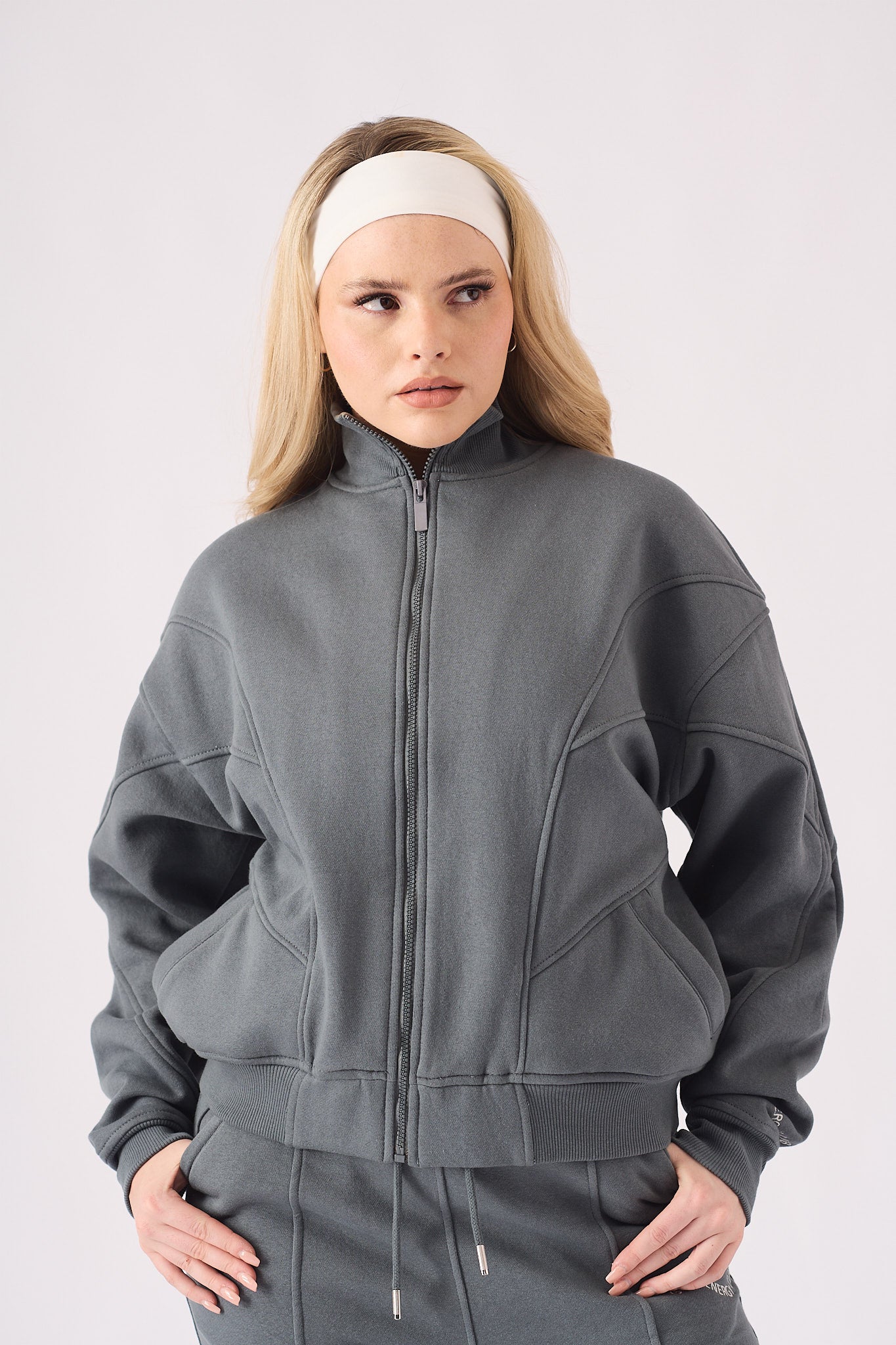 Front view detail of the stylish funnel neck on a grey zip up hoodie