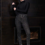 Model posing in Herman & Co black acid wash skinny jeans