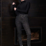Model posing in Herman & Co black acid wash skinny jeans