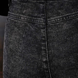 Close-up of the black Herman & Co logo patch on the back of the jeans