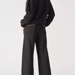 Back view of the Herman black wide-leg joggers, highlighting the blanket stitch detail on the rear patch pocket.