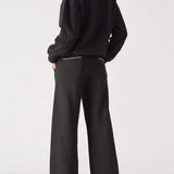 Back view of the Herman black wide-leg joggers, highlighting the blanket stitch detail on the rear patch pocket.