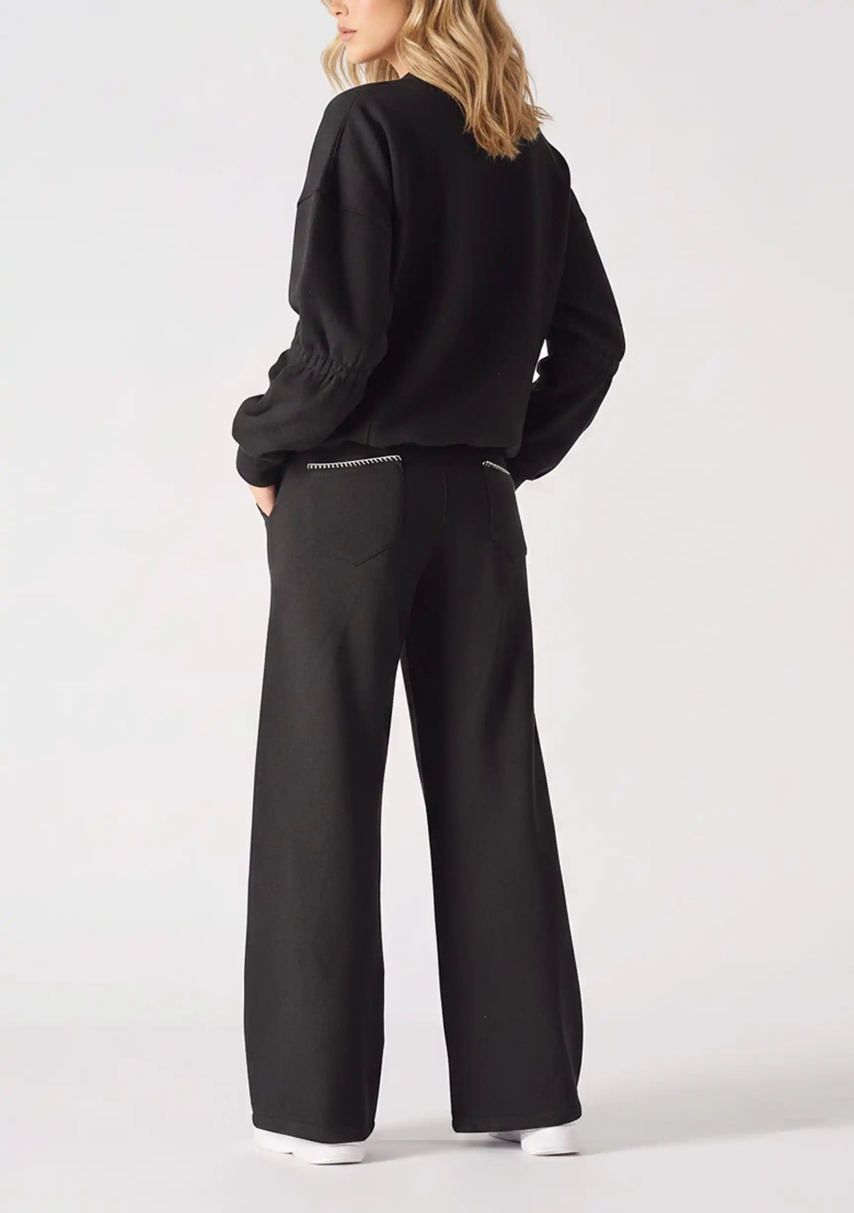 Back view of the Herman black wide-leg joggers, highlighting the blanket stitch detail on the rear patch pocket.