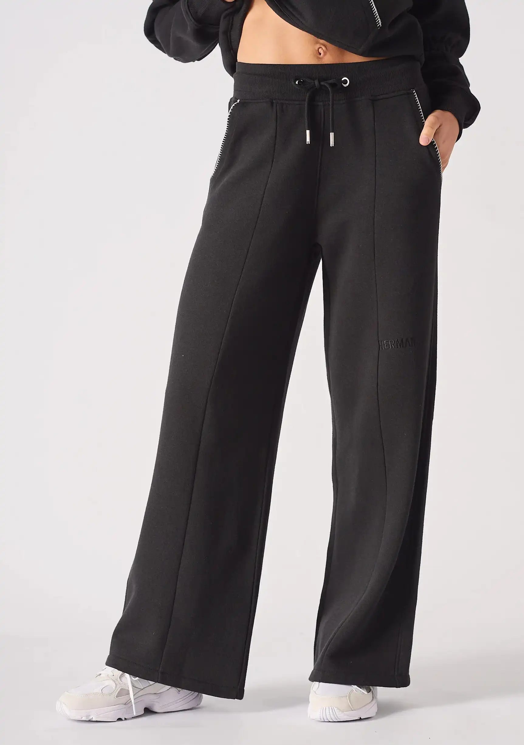 Angled front view of the Herman black wide-leg joggers made from a soft cotton blend jersey.
