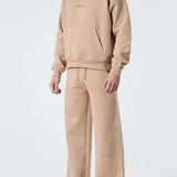 Angled view of the Herman men's beige popper neck hoodie, highlighting the oversized silhouette.