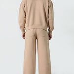 Back view of the Herman men's beige tracksuit, showing the oversized fit of the hoodie.