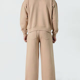 Back view of the Herman men's beige tracksuit, showing the oversized fit of the hoodie.