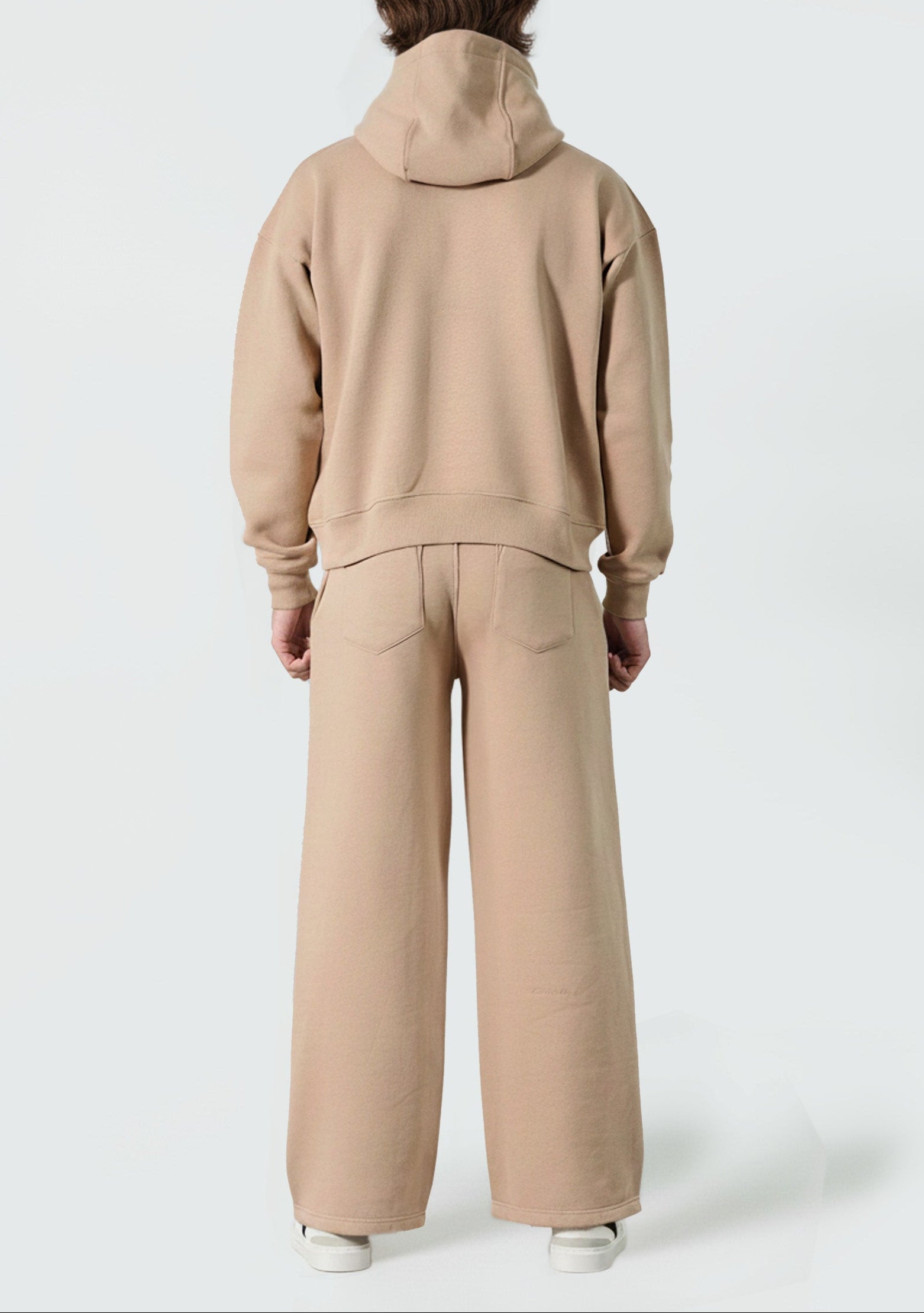 Back view of the Herman men's beige tracksuit, showing the oversized fit of the hoodie.