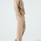 Side profile of the Herman men's beige popper neck hoodie and joggers set.