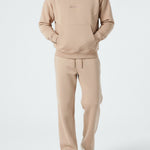 Model styled in the full Herman men's beige loungewear tracksuit.