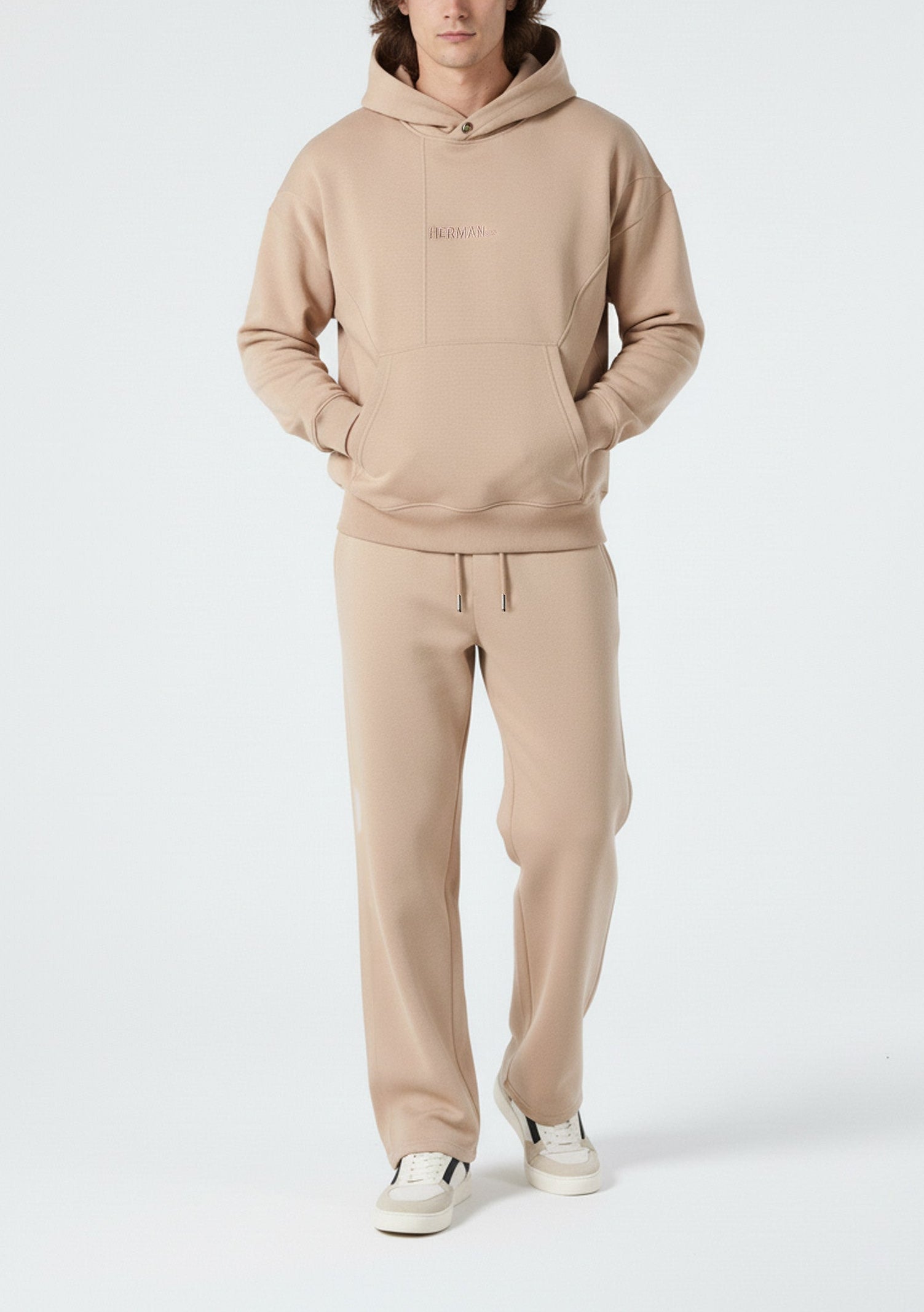 Model styled in the full Herman men's beige loungewear tracksuit.
