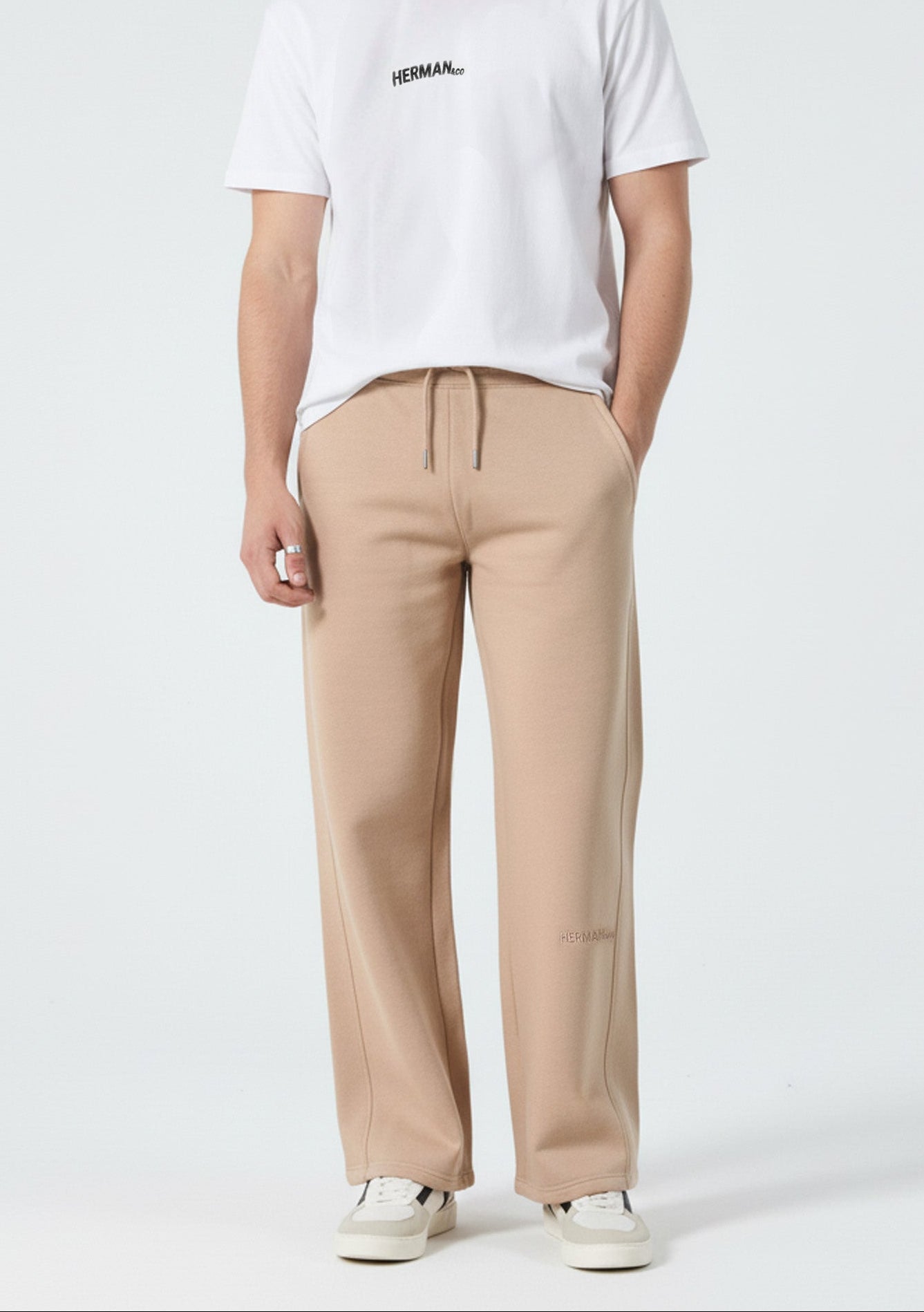 Front view of the Herman men's beige wide-leg joggers styled with a white t-shirt.